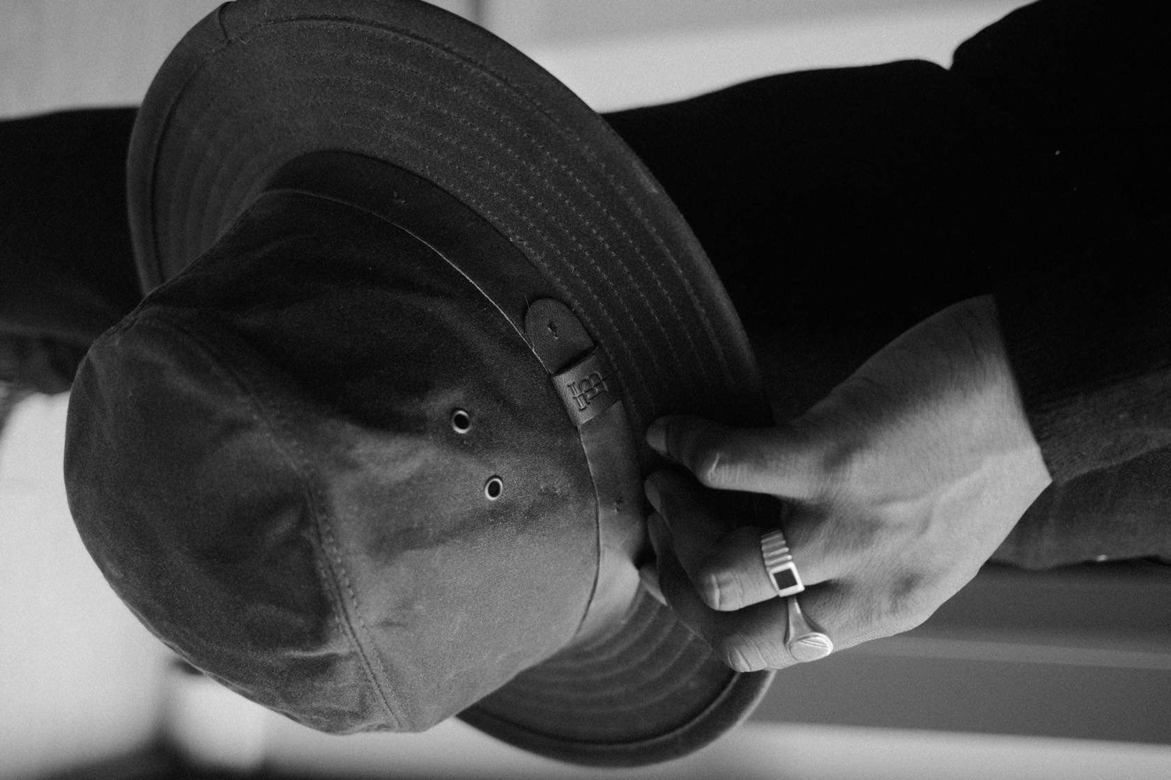 Waxed cotton hat in hand